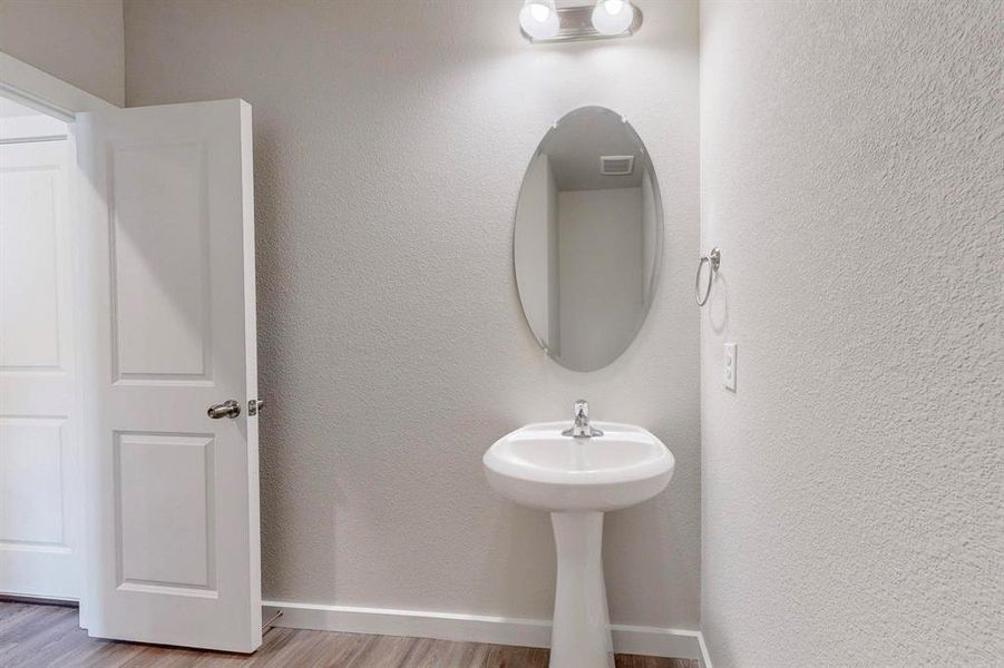 Bathroom with baseboards and light wood finished floors