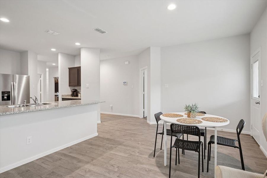 Dining area featuring light wood-type flooring and recessed lighting. Dining area featuring light wood-type flooring and recessed lighting.