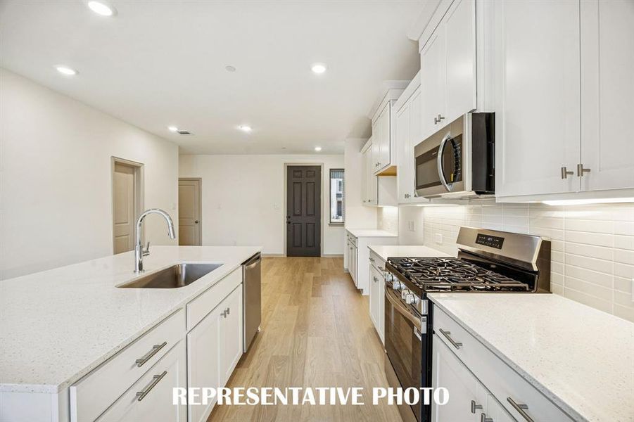 Beautiful cabinetry, gorgeous countertops and classic backsplash effortlessly combine with contemporary stainless steel to create your dream kitchen!  REPRESENTATIVE PHOTO