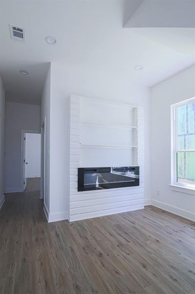 Unfurnished living room with dark hardwood / wood-style floors