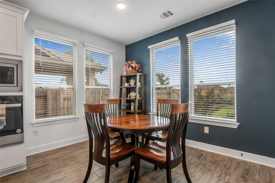Dining room with baseboards and light wood-type flooring Dining room with baseboards and light wood-type flooring
