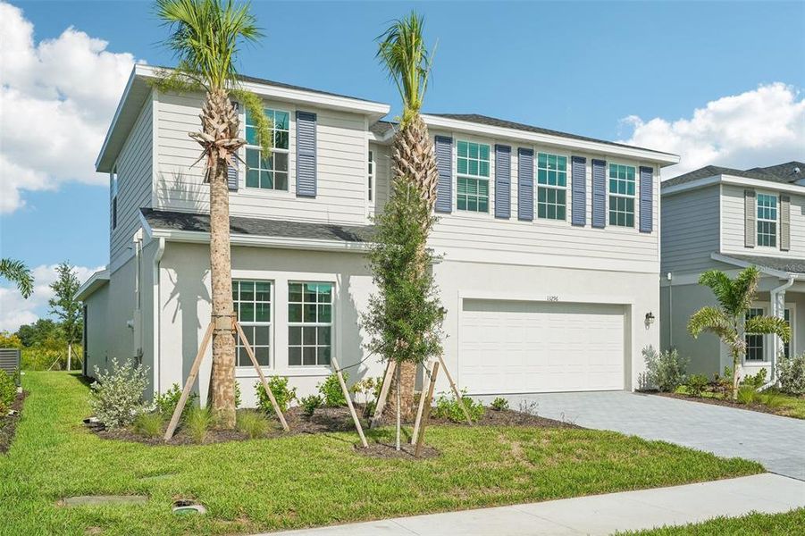 Front exterior of a new home in Lennar at Turnleaf, Punta Gorda, FL, highlighting curb appeal (Image 2). Front exterior of a new home in Lennar at Turnleaf, Punta Gorda, FL, highlighting curb appeal (Image 2).