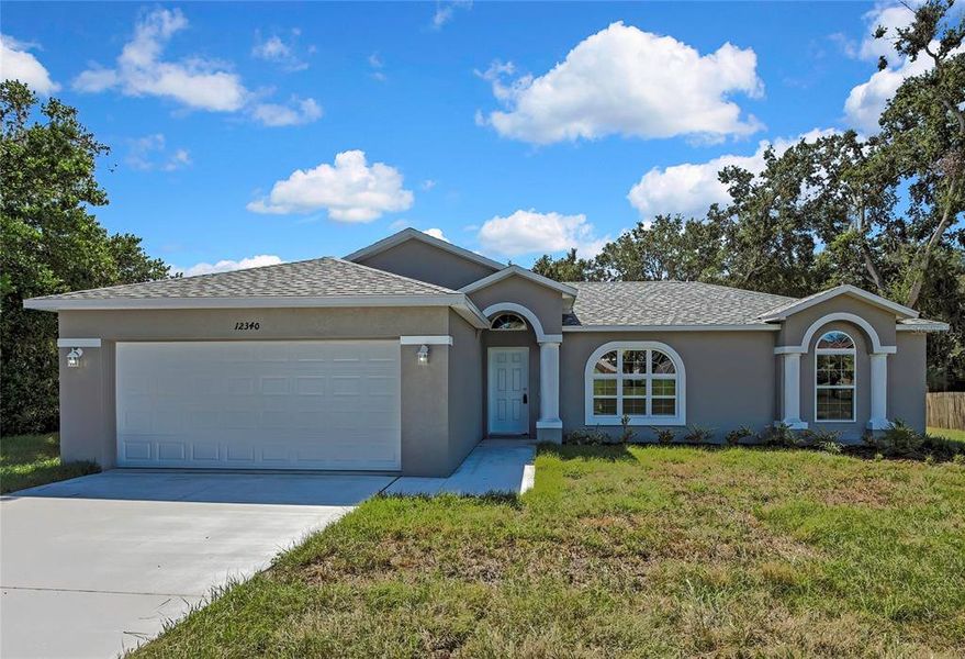 Front exterior of a new home in , Brooksville, FL, highlighting curb appeal (Image 1).