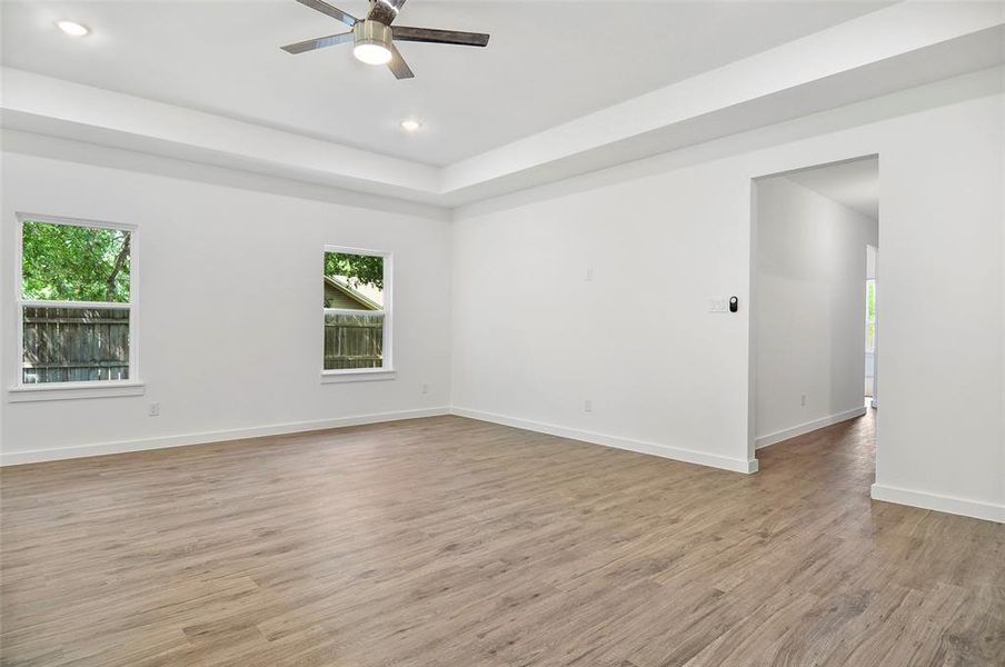 Empty room with light hardwood / wood-style floors and ceiling fan