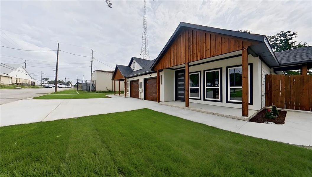 Modern exterior featuring a prominent covered porch with wood-finish vertical siding and stout posts
