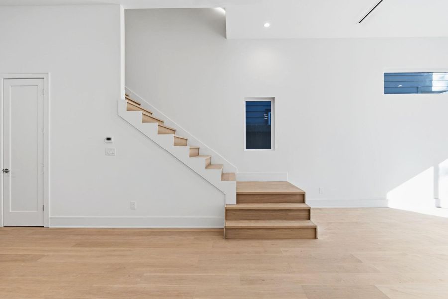 Solid Oak stair treads with glass railing system.