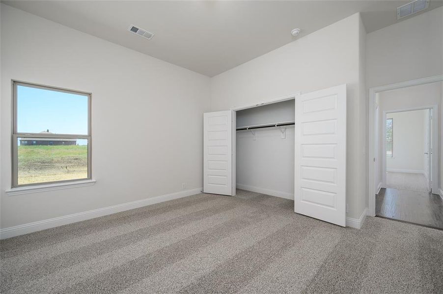 Unfurnished bedroom with a closet and carpet flooring