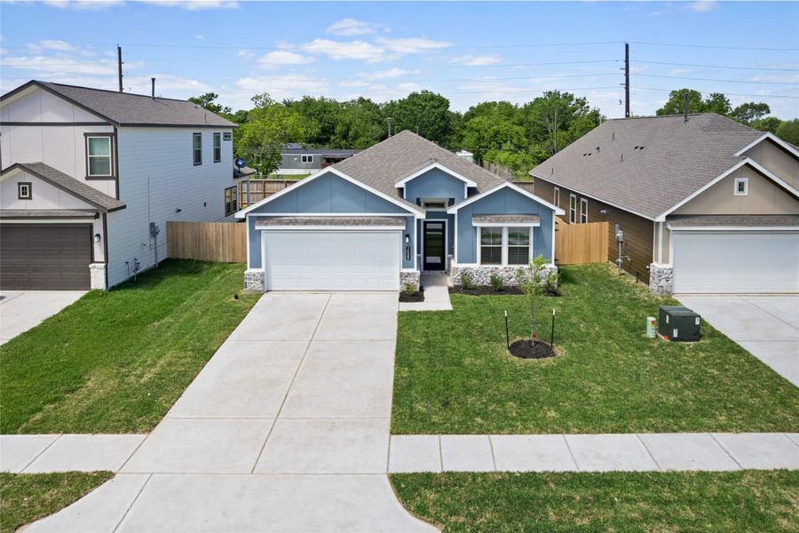 Front exterior of a new home in Crosby Farms, Crosby, TX, highlighting curb appeal (Image 2). Front exterior of a new home in Crosby Farms, Crosby, TX, highlighting curb appeal (Image 2).