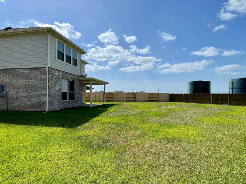 Front exterior of a new home in Sunterra, Katy, TX, highlighting curb appeal (Image 2). Front exterior of a new home in Sunterra, Katy, TX, highlighting curb appeal (Image 2).