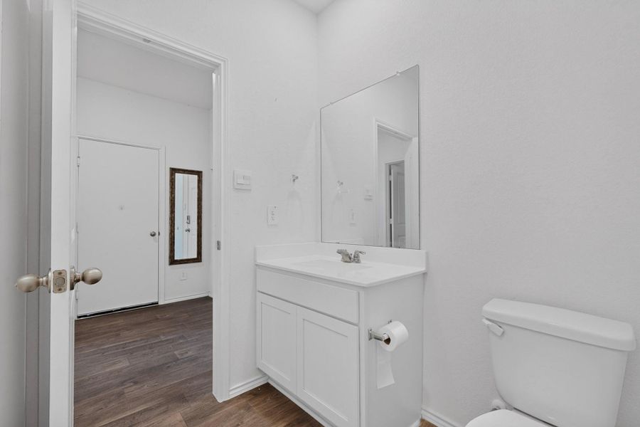 Clean lines and stone counters highlight this updated powder room space. Clean lines and stone counters highlight this updated powder room space.