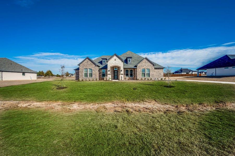 Front exterior of a new home in The Arbors Midlothian, Midlothian, TX, highlighting curb appeal (Image 1).