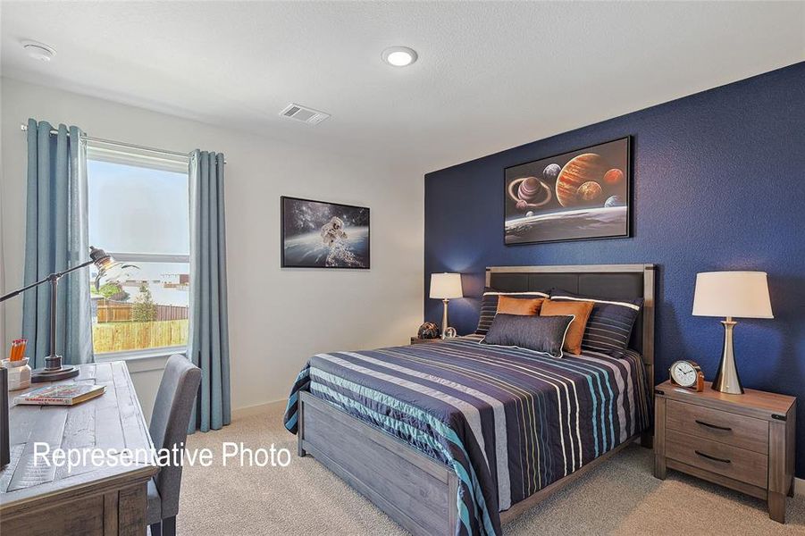 Bedroom featuring a prominent accent wall in a deep blue hue