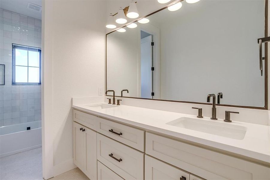 Bathroom with vanity and a tub