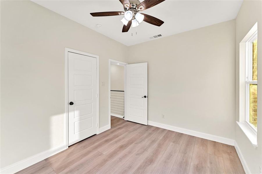 Unfurnished bedroom featuring light hardwood / wood-style floors and ceiling fan