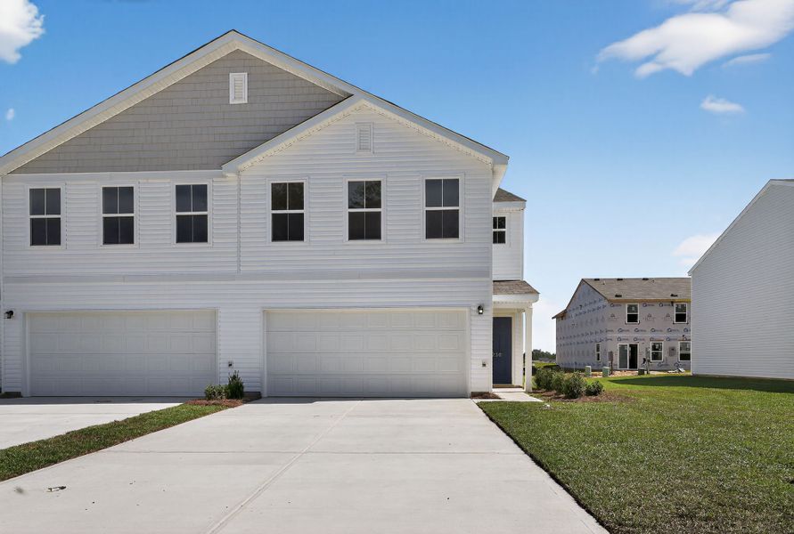 A white house with a driveway. A white house with a driveway.