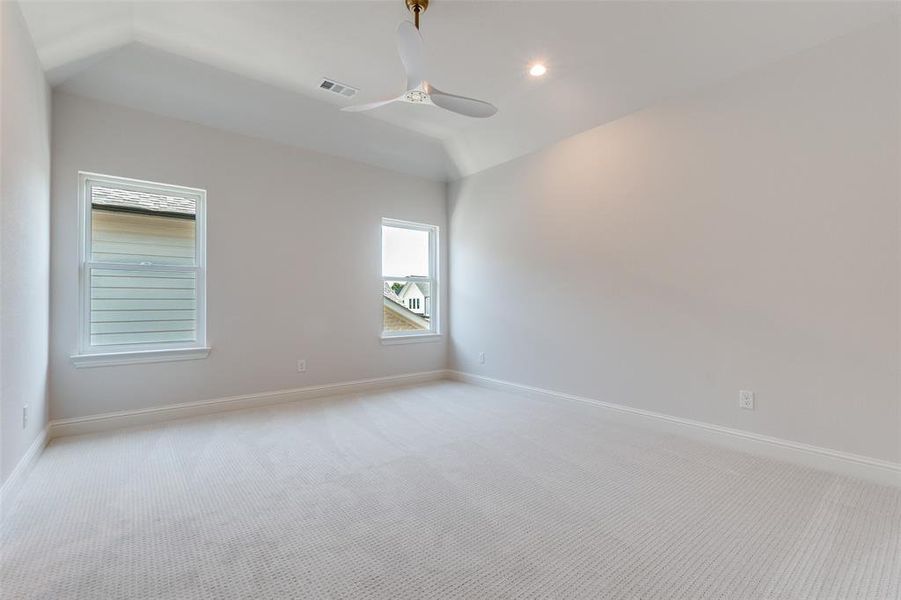 Carpeted spare room with recessed lighting, vaulted ceiling, and a ceiling fan Carpeted spare room with recessed lighting, vaulted ceiling, and a ceiling fan