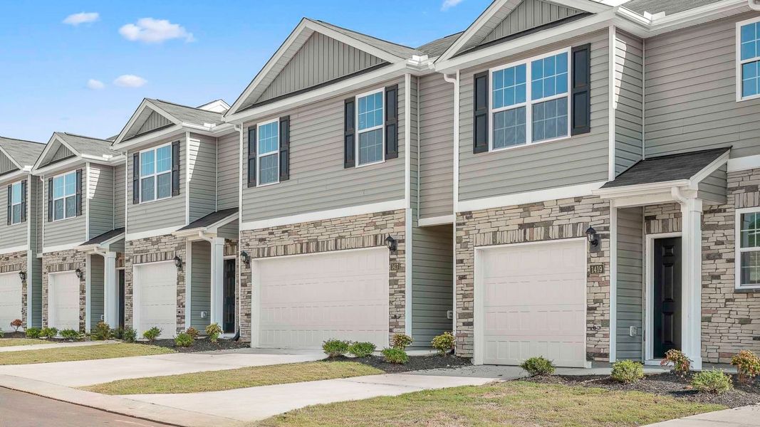 Front exterior of a new home in North Village Townes, Greensboro, NC, highlighting curb appeal (Image 2). Front exterior of a new home in North Village Townes, Greensboro, NC, highlighting curb appeal (Image 2).