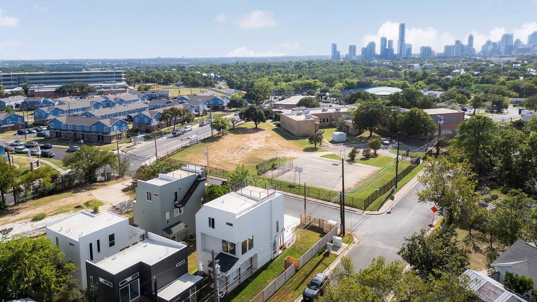 Aerial perspective of suburban area featuring city skyline