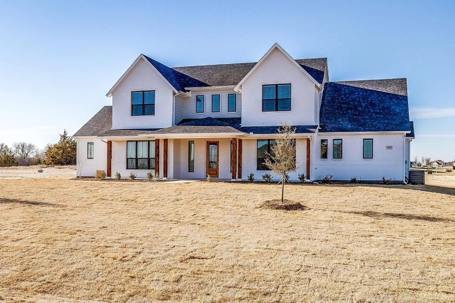 Front exterior of a home in the Wooded Creek community, located in Waxahachie, TX (Image 4).