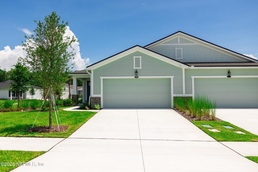 Front exterior of a new home in RiverTown - WaterSong, St. Johns, FL, highlighting curb appeal (Image 22).