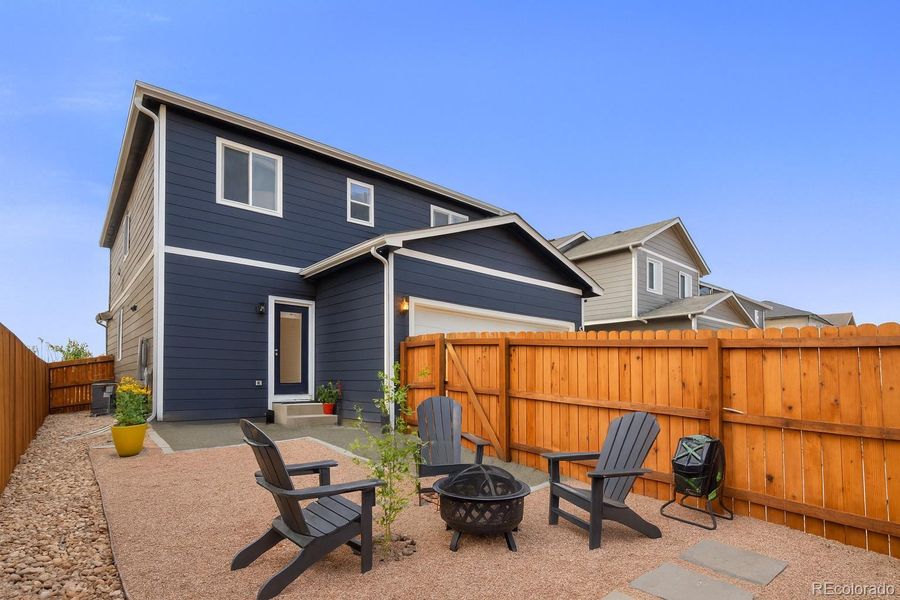 Fully fenced back yard to entertain and relax in. Currently xeriscaped, but could add grass or artificial turf. Gate to driveway/alley.