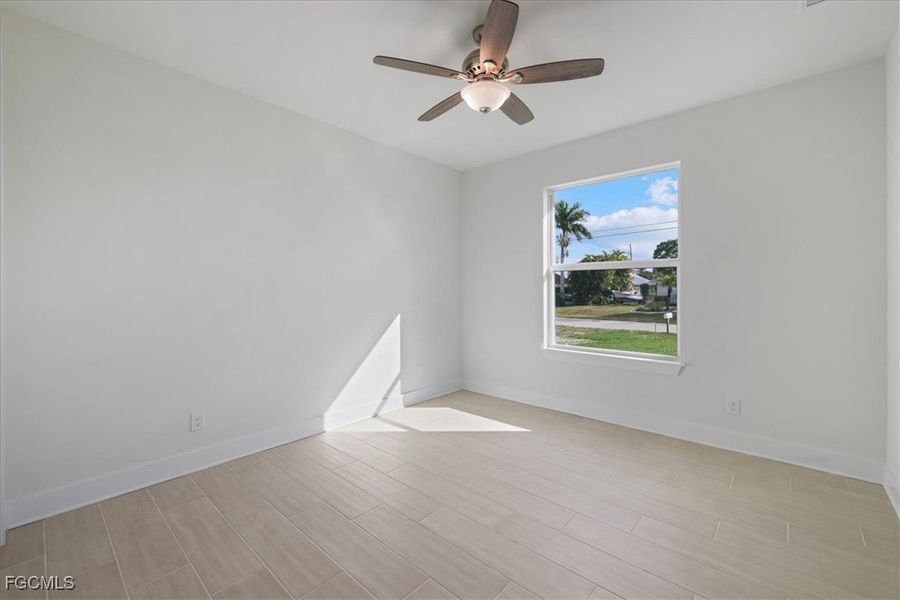 Spare room featuring wood tiled floors and a ceiling fan