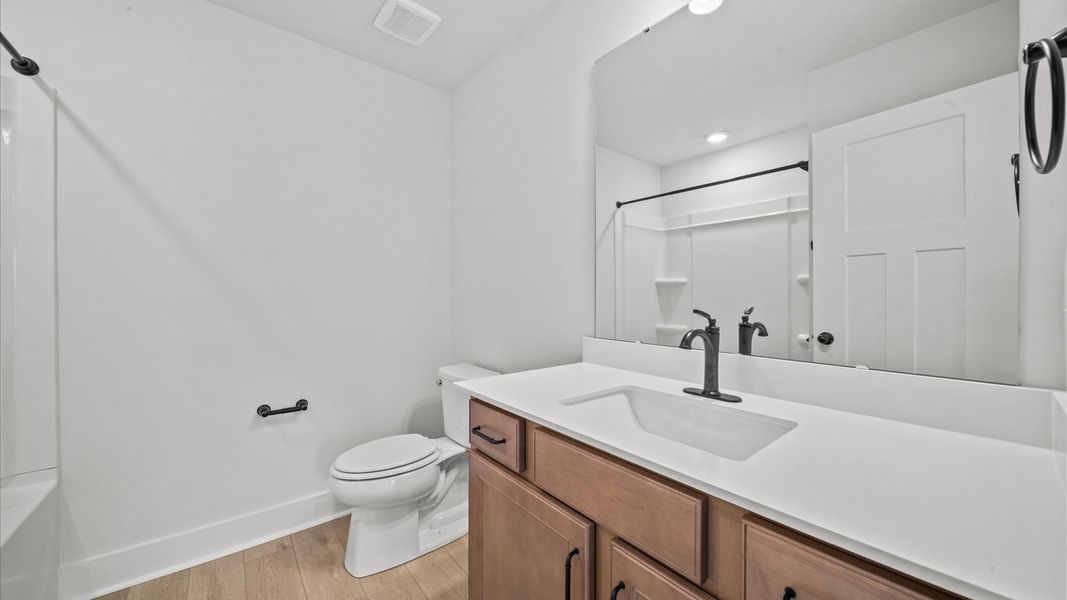 Highly skilled design seen in this polished and practical full bathroom