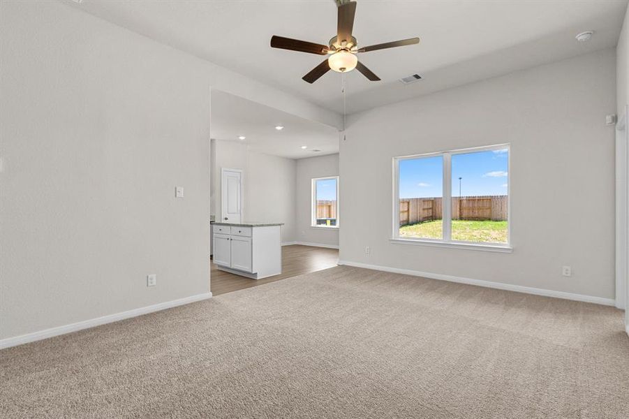 The cozy living room overlooks the covered back patio and backyard.