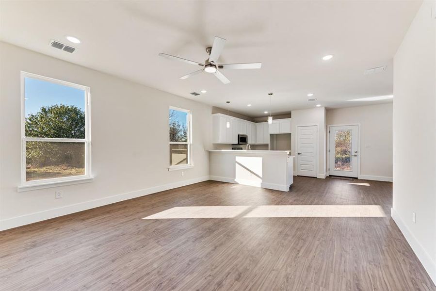 Kitchen with white cabinets, light wood-type flooring, and plenty of natural light