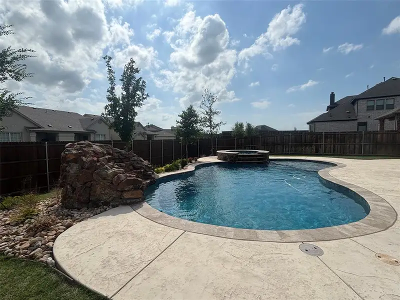 Beautiful pebble pool and landscaping