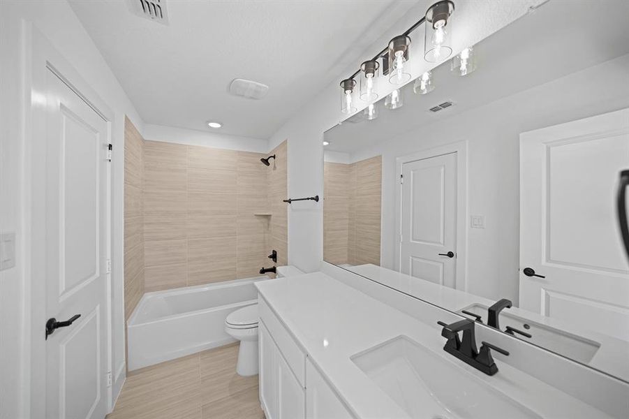 Full bathroom featuring vanity and shower / bathtub combination Full bathroom featuring vanity and shower / bathtub combination