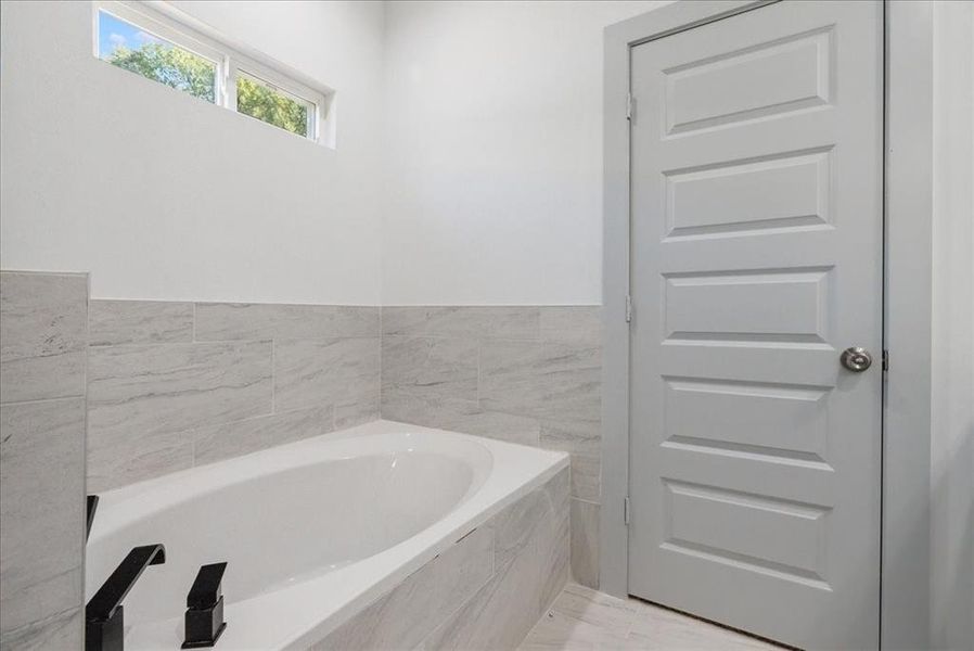 Bathroom with tiled bath