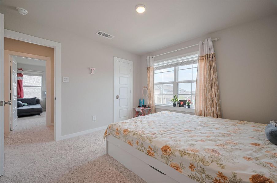 Bedroom with hardwood-style flooring.