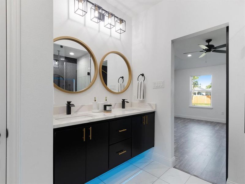 Bathroom with vanity, ceiling fan, hardwood / wood-style flooring, and an enclosed shower