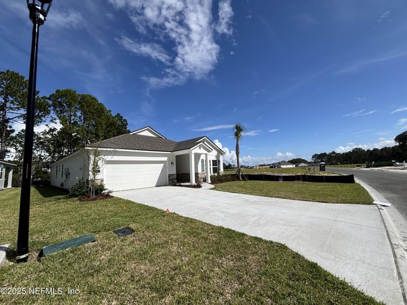 Front exterior of a new home in The Magnolia Series at Reserve East, Flagler Beach, FL, highlighting curb appeal (Image 16).