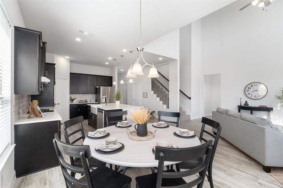 Dining area with light wood-type flooring and ceiling fan