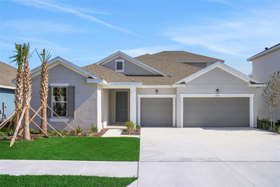Front exterior of a new home in Angeline, Land O' Lakes, FL, highlighting curb appeal (Image 20).