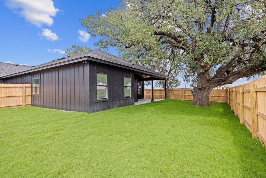 A spacious backyard with mature trees provides ample space for outdoor enjoyment. A spacious backyard with mature trees provides ample space for outdoor enjoyment.