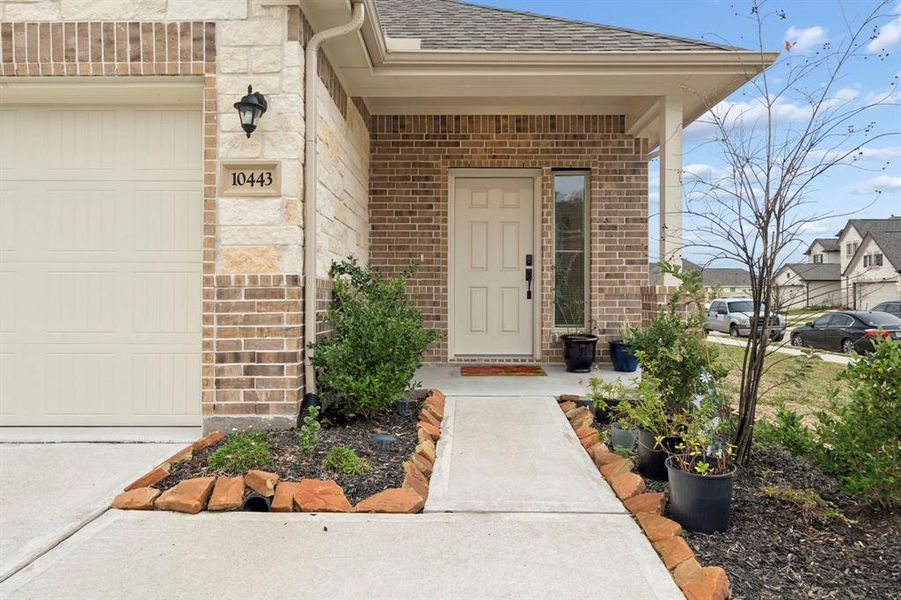 Beautiful landscaping and covered entrance