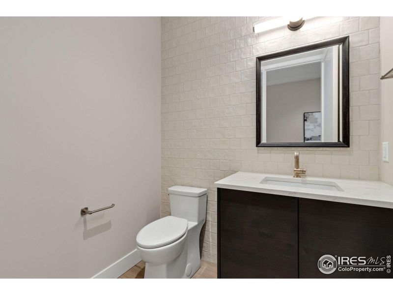 The half-bath, with a beautiful tile feature wall, is in addition to two full bathrooms attached to each bedroom.