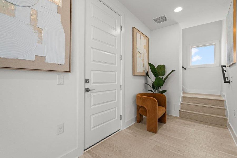 Welcoming main entry foyer.  Garage access and main floor bedroom are located off the main level entry.