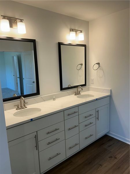 This spacious bathroom offers dual vanities with a