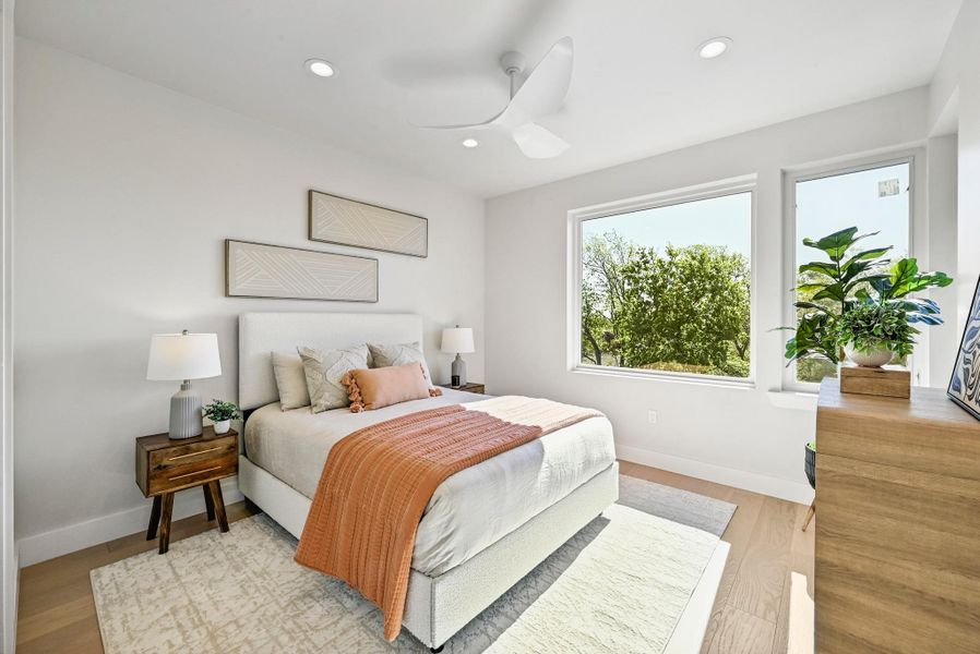 3rd Floor Primary Bedroom with scenic windows. (This is Unit #2 - each Unit has the same layout, however a few differing details such as light fixtures, custom cabinet/backsplash/tile colors)