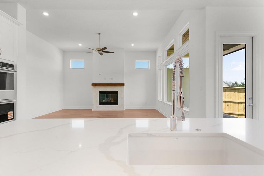 Kitchen island with an undermount sink and a polished chrome pull-down faucet