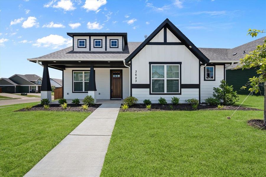 This home has a unique, traditional craftsmanship that shows in all of the interior and exterior design of this home. This covered front porch area is very open and welcoming. The solid wood front door gives it lots of character and warmth.