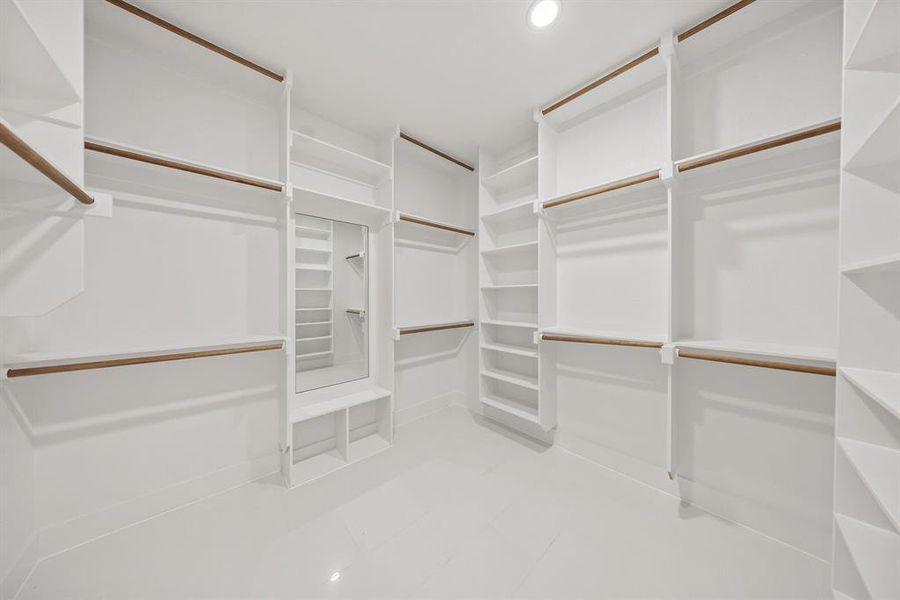 Spacious closet with light tile patterned floors
