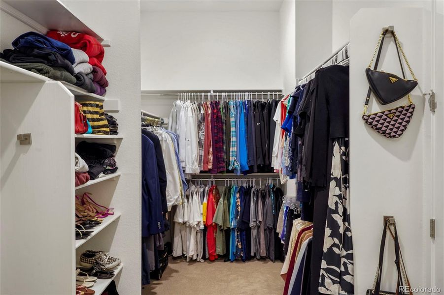 Huge primary bedroom closet with direct access to adjoining laundry room