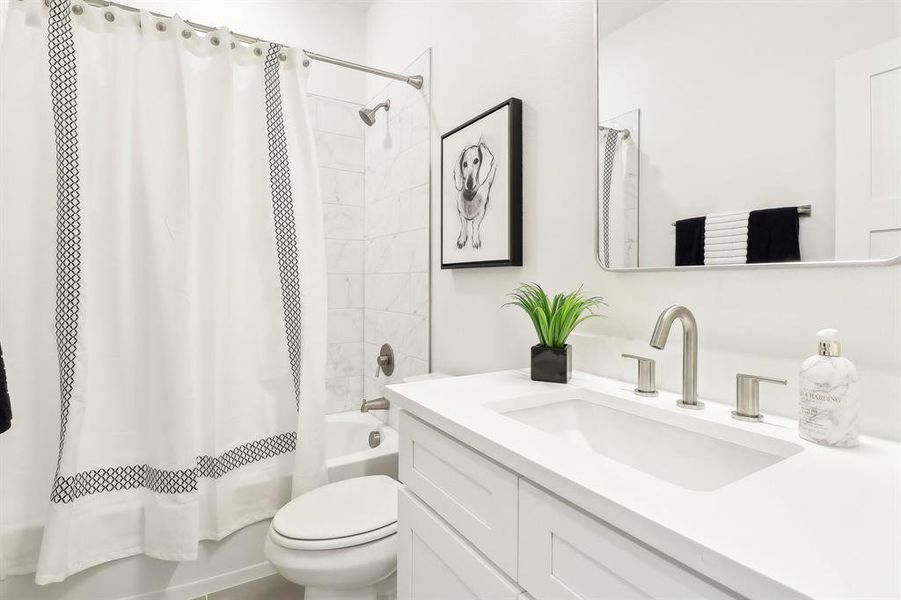 3rd floor Full bath featuring shower / bath combo, vanity, and toilet