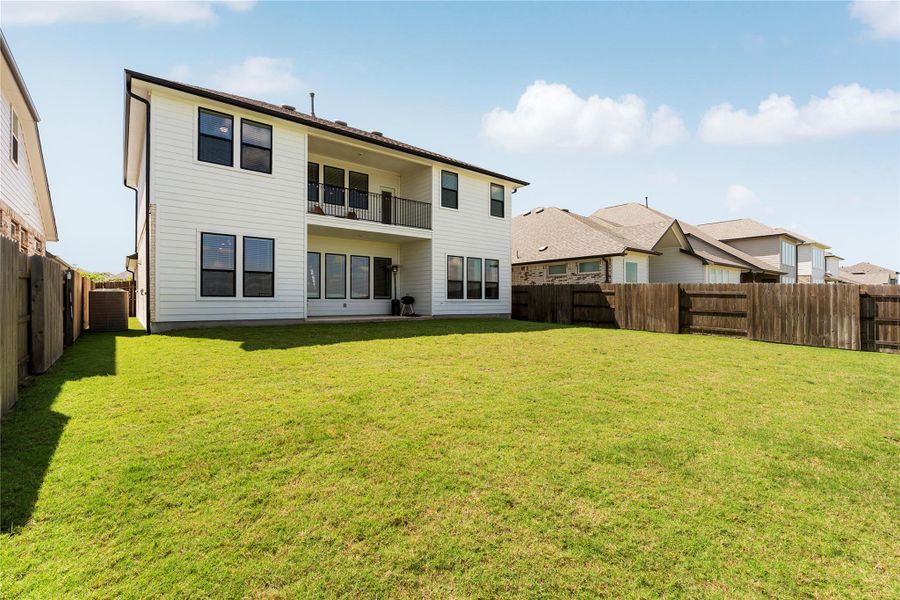 A spacious, verdant yard with a private fence offers an ideal setting for outdoor enjoyment behind this two-story residence. A spacious, verdant yard with a private fence offers an ideal setting for outdoor enjoyment behind this two-story residence.