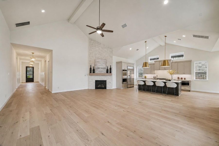 The Living Area, Kitchen, and looking down the main Hall towards the Foyer.